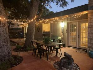 a patio with a table and chairs and lights at Hidden Haven in Canyon Lake +43 photos