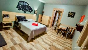 a bedroom with a bed and a table and a desk at Casal.20 Studios Flats in Cabo de Santo Agostinho +217 photos