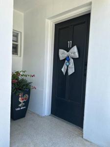 a black door with a bow on it at Villa Clara Blue-Little Havana in Miami
