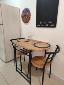 a table and two chairs with wine glasses on it at San Nicolas Apartaments in Fuengirola