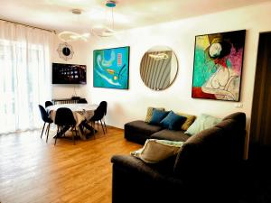 a living room with a couch and a table at Appartamento "Laghetto 1" con tre camere e bagni privati cucina in condivisione in Castel San Pietro Terme