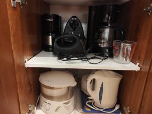 a cupboard with a coffee maker and other appliances at luxurious Mont tremblant 2bd 2bth in Mont-Tremblant