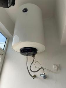 a light hanging from the ceiling in a room at Échappez à la ville , Appartement près de la nature, entre forêt et plage juste pour les familles in Skhirat +6 photos