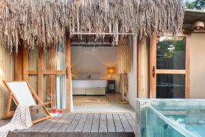 a resort with a bed and a swimming pool at Villa Rio Caraiva in Caraíva
