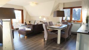 a living room with a dining table and a couch at Ferienwohnung Am Roten Turm in Meersburg
