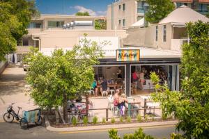 people sitting at tables outside of a restaurant at 10 Hastings Street Motel in Noosa Heads