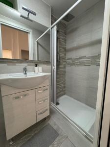a bathroom with a shower and a sink and a showerspective at desHouse in Molfetta