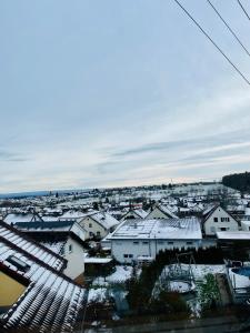 a view of a city with snow covered roofs at GHome Arigidi - Private Room in a duplex in Jettingen