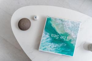 a book sitting on a table next to a shell at Seaduction in Kastraki Naxou