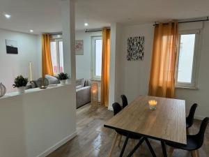 a living room with a wooden table and chairs at Maison aux portes de Strasbourg moderne et tout confort in Schiltigheim