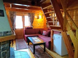 a living room with a couch and a staircase at Chata na Antošáku in Ždiar
