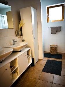 a bathroom with a sink and a mirror at Modern Mountain Apart 6 - an der Skipiste in Rauris