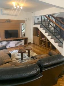 a living room with a couch and a staircase at HSH France-Villa Sicilia avec piscine proche de la plage in Grand Baie +14 photos