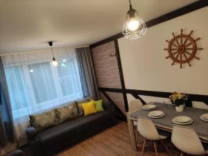 a living room with a couch and a table at SŁONECZNIK in Ostrowo