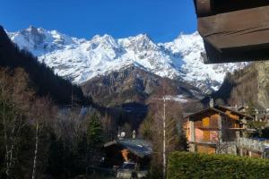 a view of a snow covered mountain from a house at Lovely Home with Breathtaking View of Mont Blanc in Courmayeur