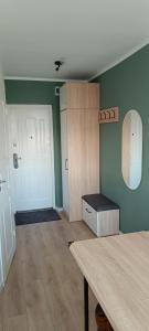a room with a door and a room with a table at SKY Studio flat in Panevėžys