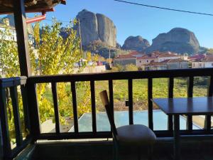 a balcony with a table and a view of mountains at Kostis Hause in Kastraki