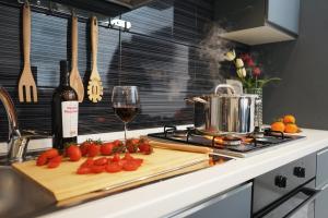 a kitchen counter with a cutting board with a glass of wine at Lume Guest House in Catania +33 photos