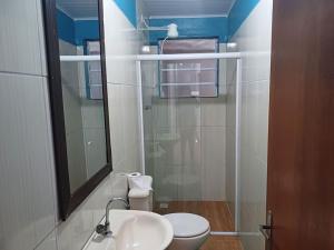 a bathroom with a toilet and a sink and a mirror at Seu descanso merecido está aqui in São Sebastião +3 photos