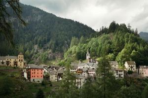 a village on a hill with a mountain at Appartement Pineta in Fusio +5 photos