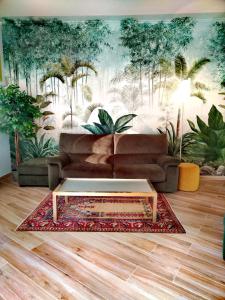 a living room with a couch and a coffee table at Jungle Sunshine Apartment in Alessandria