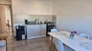 a kitchen with a table and a kitchen with a stove at La casona in Río Grande