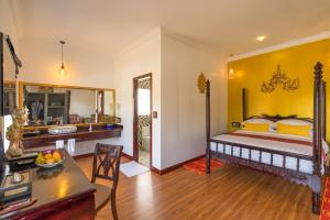 a bedroom with a king sized bed and a living room at Beyond Yangon Inn in Siem Reap