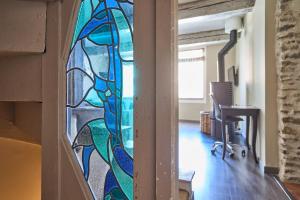 an office with a stained glass window on the wall at Les Bellevue Cité Trivalle, Cité 500m, free private car park on demand, free public car park 200m, aircon, WIFI, Cité view terrace in Carcassonne