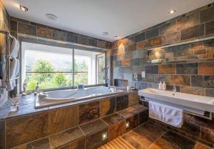 a large bathroom with a tub and a window at Invercreran House in Appin +43 photos