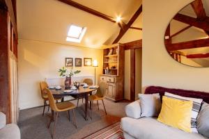 a living room with a table and a couch at Cosy 2 bedroom apartment, terrace with Hot Tub 8am - 10pm plus private daily use of indoor pool and sauna 1 hour in Stanton in Peak