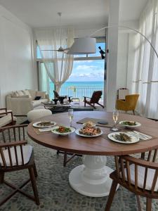 a living room with a table with plates of food at Les Paletuviers in Marigot