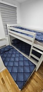 a bedroom with two bunk beds in a room at Apartman Panorama in Bjelašnica