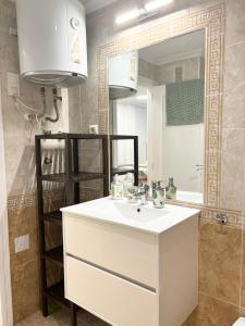 a bathroom with a sink and a mirror at Lemon Apartment - Aquamarina Cabo Roig in Playas de Orihuela