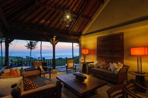 a living room with a view of the ocean at Villa Nirwana in Tanah Lot