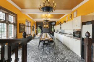 a dining room with a long table and a chandelier at Riber Hall in Matlock Bank