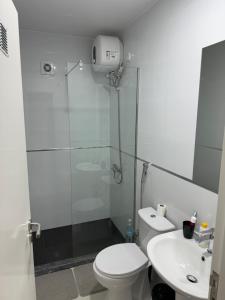 a bathroom with a shower and a toilet and a sink at Alojamento Ribeirinha in Mindelo +11 photos