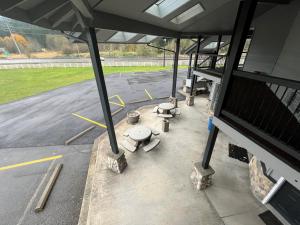an empty parking lot with tables and seats in a bus at Seasons Motel in Morton +16 photos