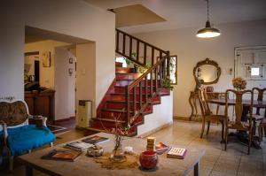 a living room with a staircase and a table at Casa mansa in Unquillo