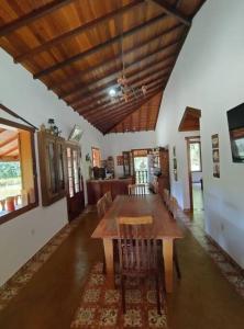 a dining room with a wooden table and chairs at Casa à Beira da Lagoa,Tiradentes in Tiradentes