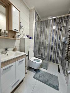 a bathroom with a toilet and a sink and a shower at Apartman Panorama in Bjelašnica +24 photos