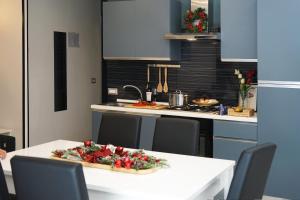 a kitchen with a white table and a counter top at Lume Guest House in Catania