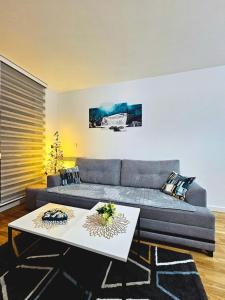 a living room with a couch and two tables at Apartman Panorama in Bjelašnica