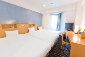 Postel nebo postele na pokoji v ubytování Shibuya Tobu Hotel