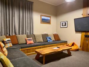 a living room with a couch and a coffee table at Station Lodge in Ohakune
