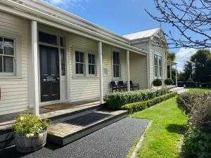 a house with a front porch and a yard at Station Lodge in Ohakune
