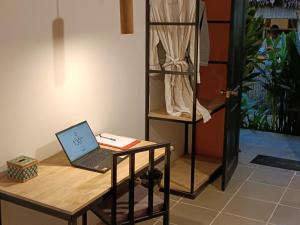 a desk with a laptop on it next to a closet at Madam Sokha Homesteading in Siem Reap +72 photos