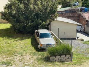 a white van parked in a yard next to a building at Zsolnay Walk-Up in Pécs