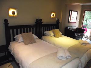 A bed or beds in a room at Njala Guest House