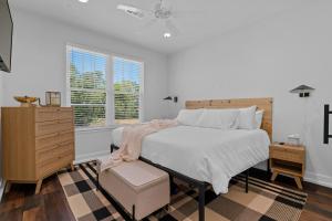 a bedroom with a large bed and a dresser at The Betty, on 2 acres Hot tub & 2 King Beds in Hot Springs