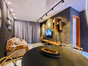 a living room with a table and a couch at Patacho Porto Gamboa in Pôrto de Pedras